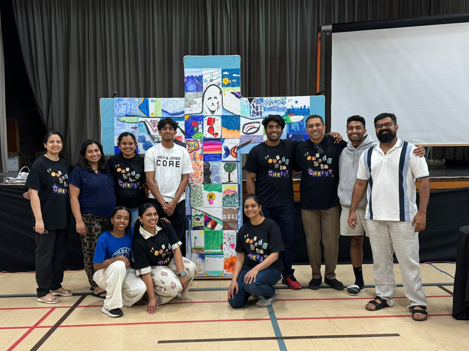 Jesus Youth community around a creative cross